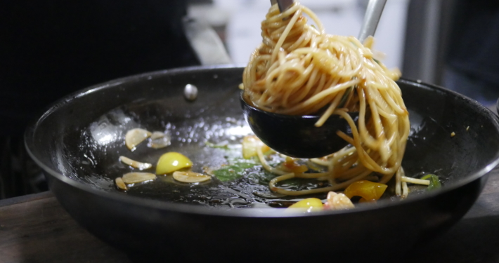 Image of Chef Winnie cooking fresh spaghetti live at BLISS Restaurant Siargao