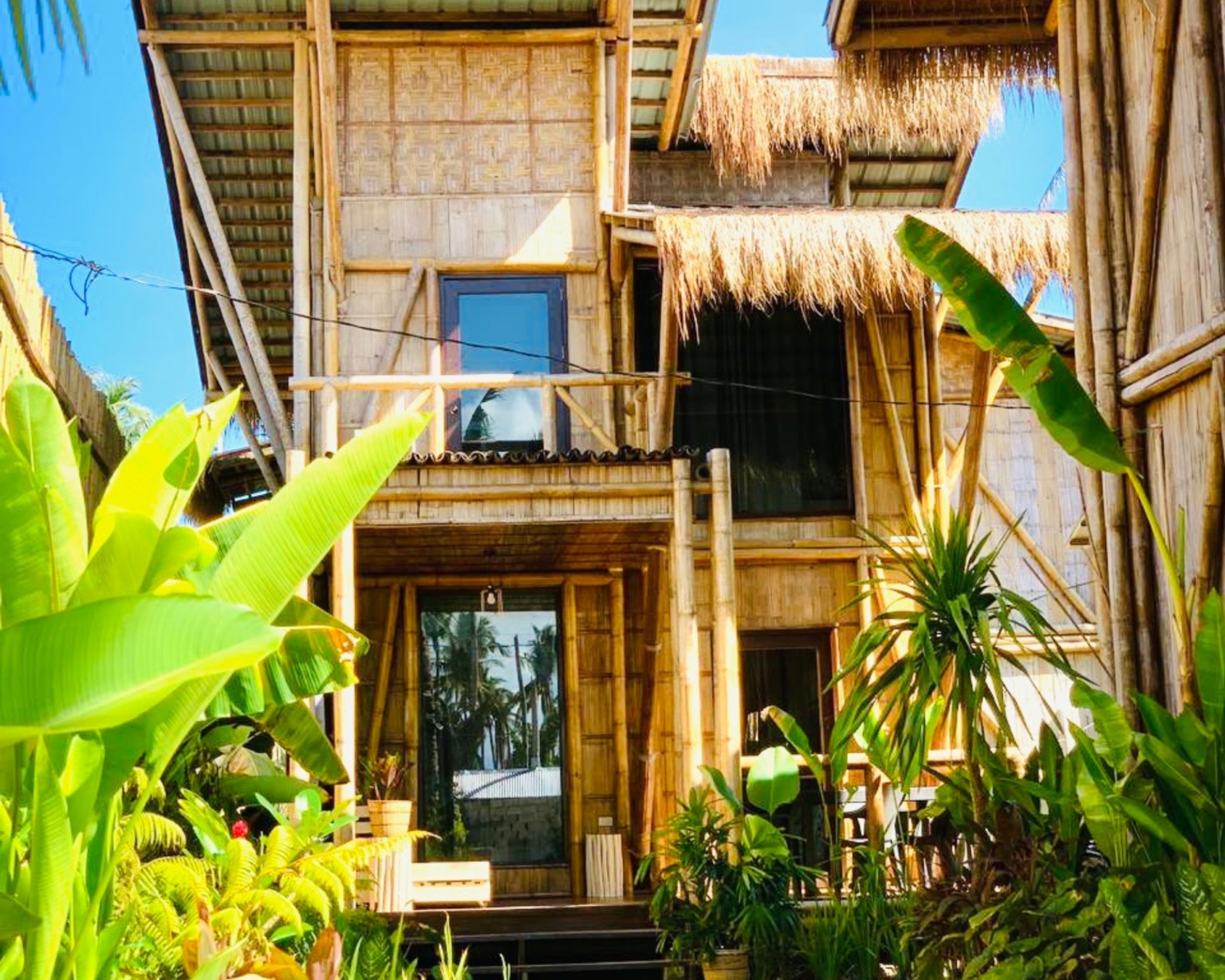 Outside perspective of the Family Home accommodation, nestled in lush tropical surroundings at BlissBamboo Homestay in Siargao.